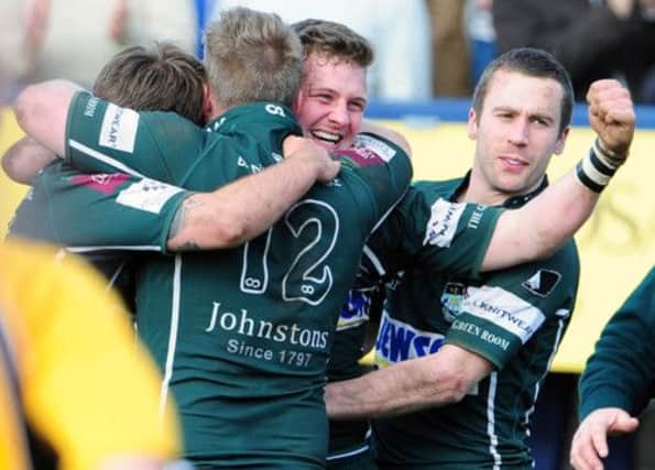 Graham Hogg (12), Rory Hutton and John Coutts celebrate Hawick's 39-38 promotion play-off win against Dundee. Picture: Ian Rutherford