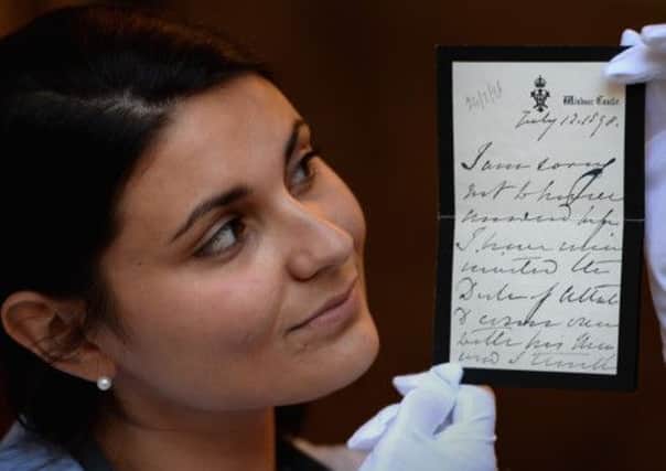 Maria Baskhanova of Bonhams displays a letter written by Queen Victoria. Picture: Getty
