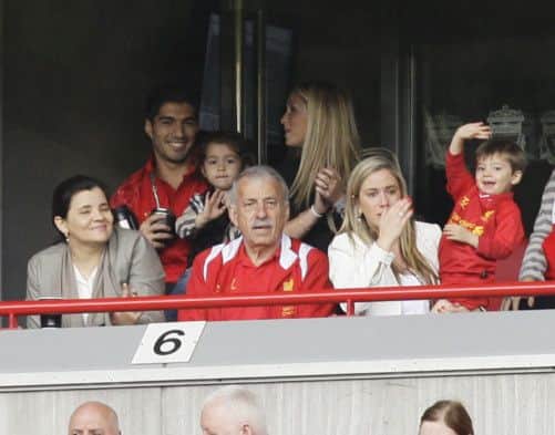 Home sweet home: Luis Suarez, who is staying at Liverpool, enjoys yesterday's game with his family. Picture: AP