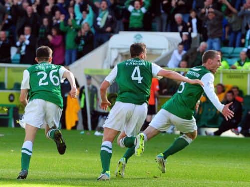 Scott Robertson, right, wheels away in delight after scoring Hibs equaliser and denying his old club victory. Picture: Ian Rutherford