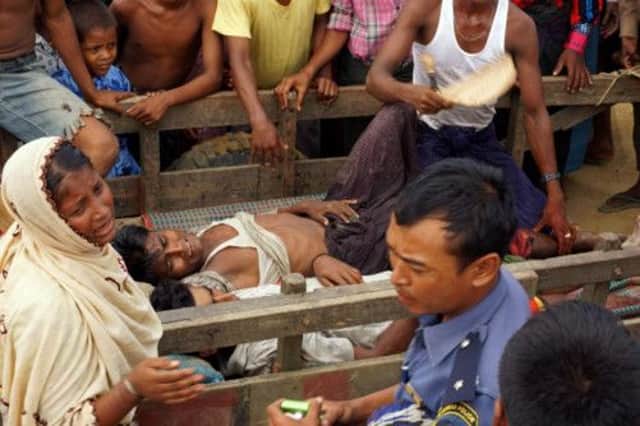 The injured are evacuated following violence at a Rohingya refugee camp in Rakhine state. Picture: AFP/Getty