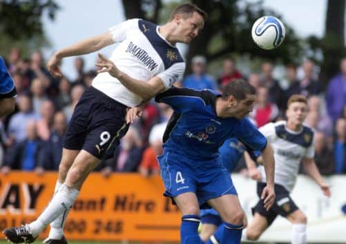 Rangers striker Jon Daly, left, outjumps Stranraers Scott Robertson at Stair Park. Picture: PA