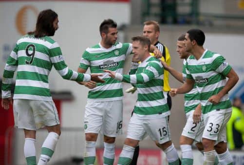 Kris Commons is surrounded by team-mates after converting from the penalty spot to open the scoring against Aberdeen. Picture: PA