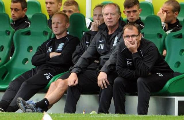 Hibs manager Pat Fenlon and assistant Jimmy Nicholl look on from the dug out. Picture: Ian Rutherford