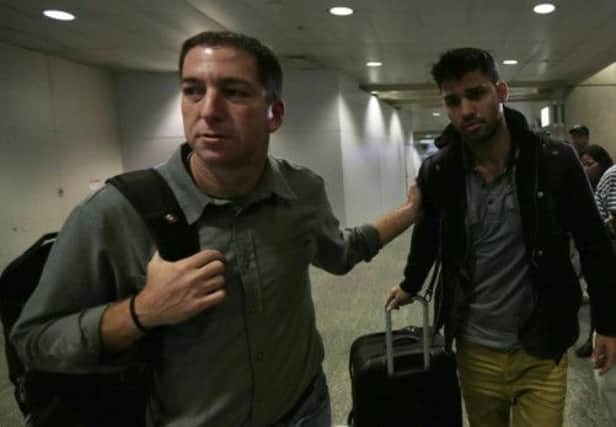 Journalist Glenn Greenwald, left, pictured with his partner David Miranda as they were leaving Rio de Janeiro. Picture: Reuters