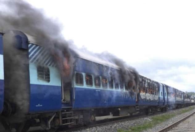 The train was set on fire by a mob angered by the deaths. Picture: AP