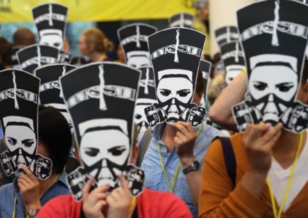 Delegates at a Berlin Amnesty International meeting wear masks                     depicting Nefertiti in a gasmask. Picture: Sean Gallup/Getty Images