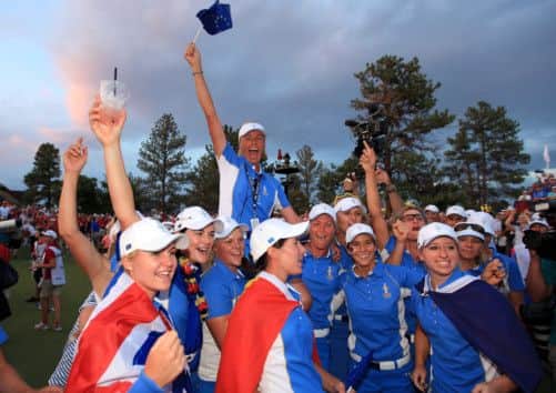 Liselotte Neumann of Sweden the European Team captain is held aloft. Picture: Getty