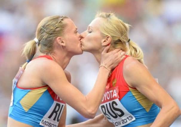Russia's Tatyana Firova and Kseniya Ryzhova kiss after winning the women's 4x400 metres. Picture: Getty/ AFP