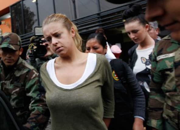 Melissa Reid, front, and Michaella McCollum Connolly, behind right, are escorted to court by police. Picture: AP
