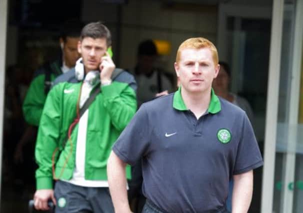 Celtic manager Neil Lennon leads the Celtic team out of Glasgow Airport. Picture: PA