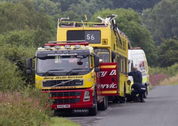 Workers take away the double-decker bus from the bridge on the A737 north of Dalry, Ayrshire. Picture: Tom Ross