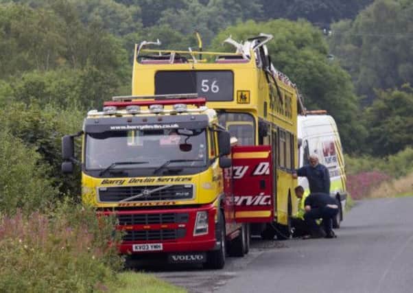 Workers take away the double-decker bus from the bridge on the A737 north of Dalry, Ayrshire. Picture: Tom Ross