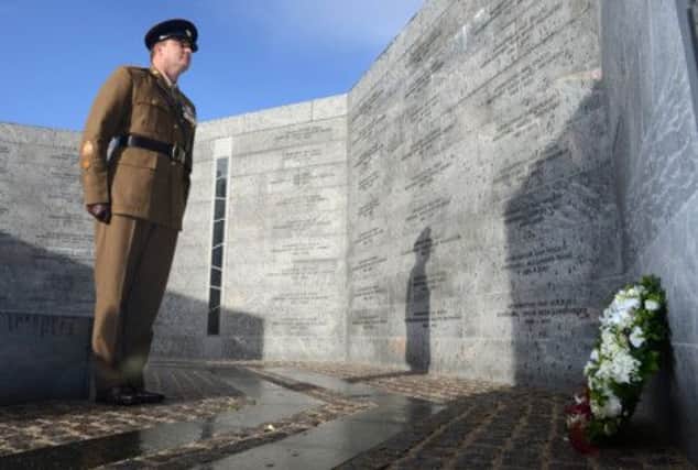 Warrant Officer Andy Peat lays a wreath at the Danish wall of remembrance after receiving his bravery award. Picture: PA