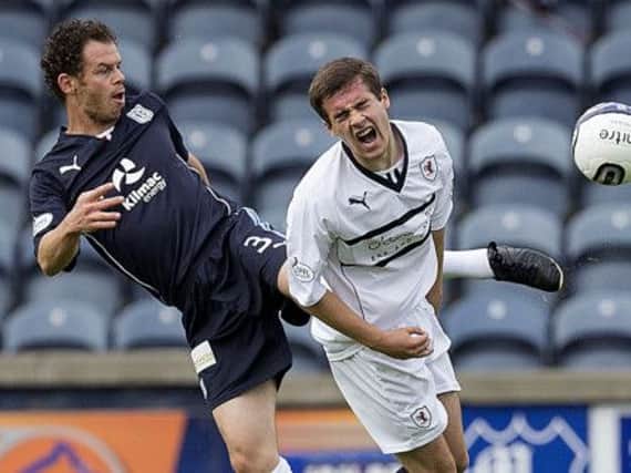 Dundee's Matt Lockwood pokes the ball away from Raith's Lewis Vaughan. Picture: SNS