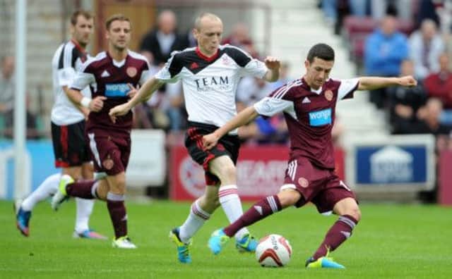 Jason Holt, a prominent figure in Hearts' midfield on Saturday, draws clear of Aberdeen's Willo Flood. Picture: Jane Barlow