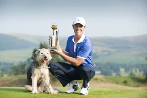 Tommy Fleetwood with his pet dog Maisy and the Johnnie Walker Championship trophy the young Englishman secured in a three-way play-off. Picture: PA