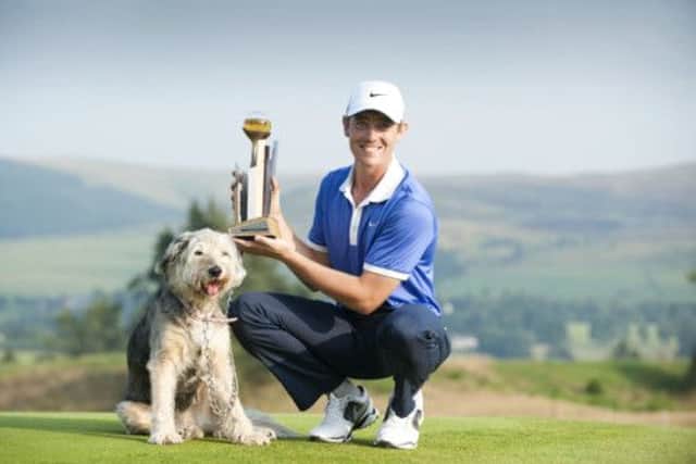 Tommy Fleetwood with his pet dog Maisy and the Johnnie Walker Championship trophy the young Englishman secured in a three-way play-off. Picture: PA