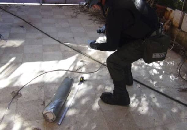 A U.N. chemical weapons expert gathers evidence at one of the sites of an alleged poison gas attack in Damascus. Picture: Reuters