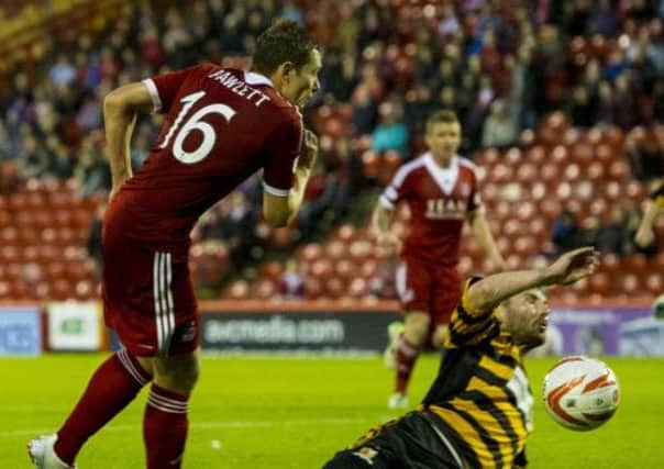 Aberdeen's Peter Pawlett appeals for a penalty after the ball appeared to strike the arm of Ben Gordon, right, in the box. Picture: SNS