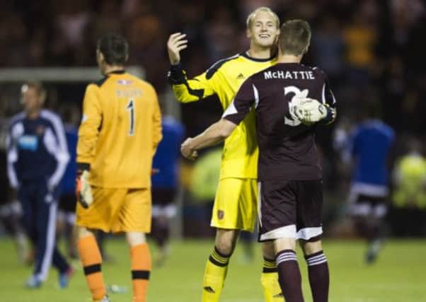 Hearts keeper Mark Ridgers celebrates after the final whistle with team mate Kevin McHattie. Picture: SNS