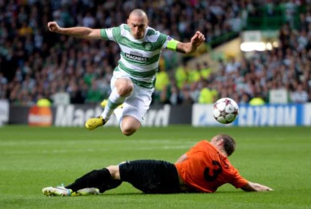 Scott Brown hurdles a challenge early in the first half. Picture: SNS