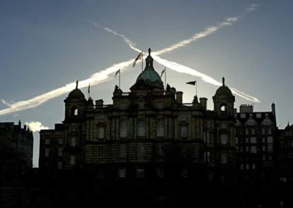 Jet streams cross over the former HBOS headquarters on Edinburgh's Mound. Picture: TSPL