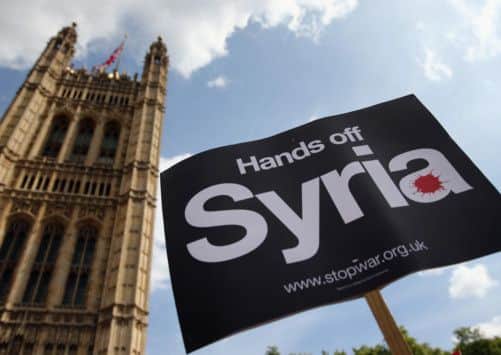 An anti-war placard is held outside the Houses of Parliament in London. Picture: Getty