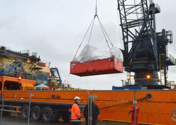 The wreckage of the Super Puma is offloaded at Lerwick from the Bibby Polaris vessel. Picture: Millgaet Media