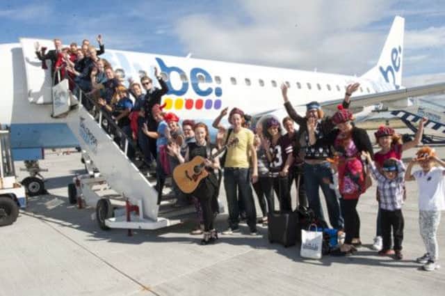 Dozens of flame-haired travellers board a special flight dedicated to redheads. Picture: PA