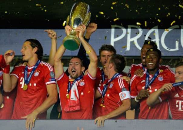 Franck Ribery of Bayern Munich lifts the European Super Cup after his side's dramatic win. Picture: Getty