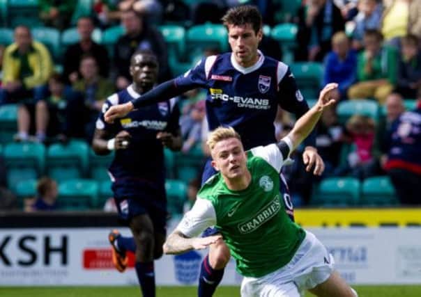 Hibernian's Danny Handling races Rocco Quinn for posession. Picture: SNS