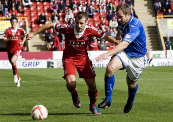 Aberdeen's Niall McGinn gets away from Frazer Wright. Picture: SNS