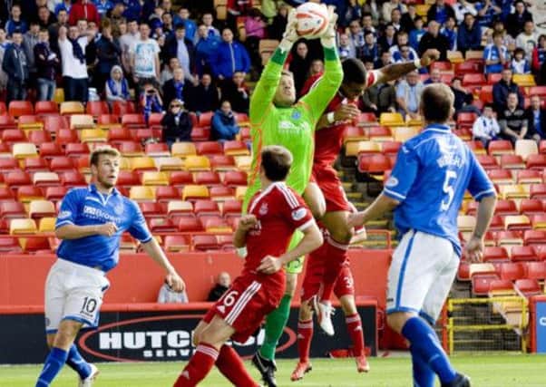 St Johnstone goalkeeper Steve Banks collects the ball ahead of Calvin Zola. Picture: SNS