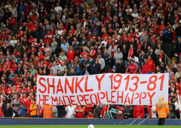 Liverpool fans in The Kop show off a banner acknowledging the 100th Anniversary of Bill Shankly's birth. Picture: Getty