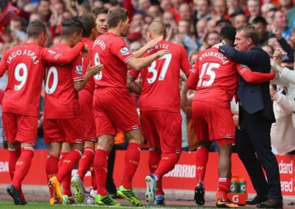 Daniel Sturridge celebrates with his teammates and manager Brendan Rodgers. Picture: Getty
