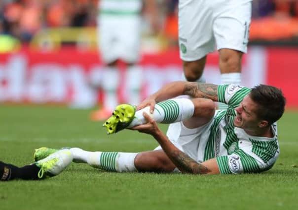 Mikael Lustig lies injured during Celtic's match with Dundee United. Picture: PA