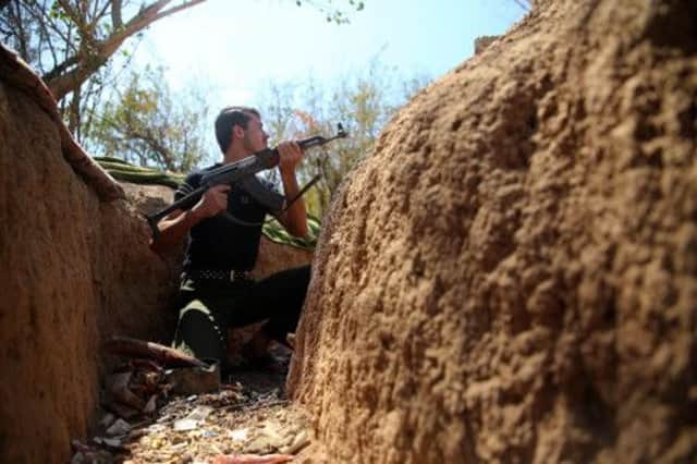 A Free Syrian Army fighter takes up position on the Idarat AlMarkabat front in Irbeen, East Gouta. Picture: Reuters