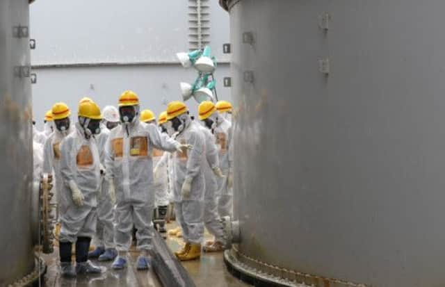 Nuclear Regulation Authority members inspect contaminated water tanks at Fukushima Dai-ichi nuclear power plant. Picture: AFP