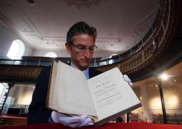 Simon Vickers looks at a first edition of the Wealth of Nations by Adam Smith. Picture: PA