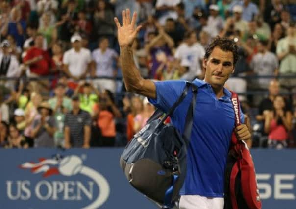 A dejected Roger Federer acknowledges the crowd after his defeat by Tommy Robredo. Picture: Clive Brunskill