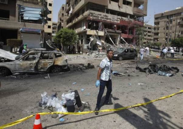 A plainclothes policeman inspects the scene of the explosion in Cairo's Nasr City district. Picture: Reuters