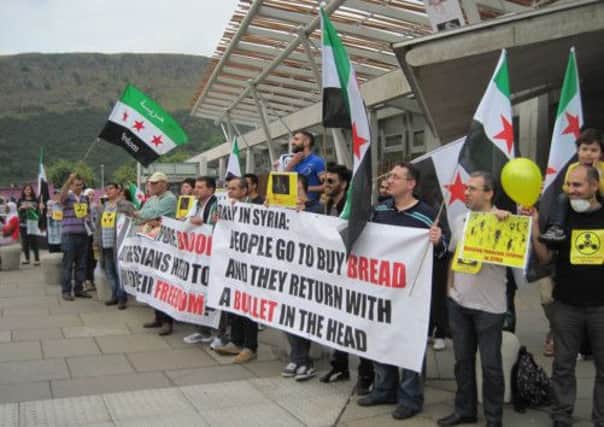 Protesters from the groups Scotland 4 Syria, Together for Syria and Free Syrians Glasgow outside the Scottish Parliament. Picture: PA