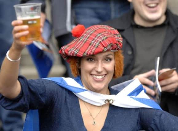 A Scotland fan has a drink at the match, but this was Murrayfield, not Hampden. Picture: Ian Rutherford