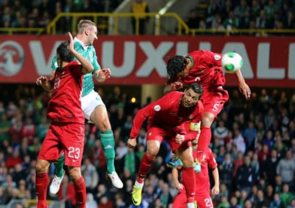 Northern Ireland's Gareth McAuley beats the Portugal defence to score. Picture: PA