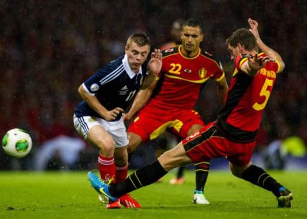 Scotland's James Forrest receives a challenge from Jan Vertonghen. Picture: SNS