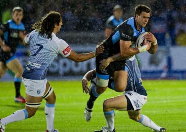 Alex Dunbar is halted by Cardiff duo Josh Navidi and Gavin Evans. Picture: SNS