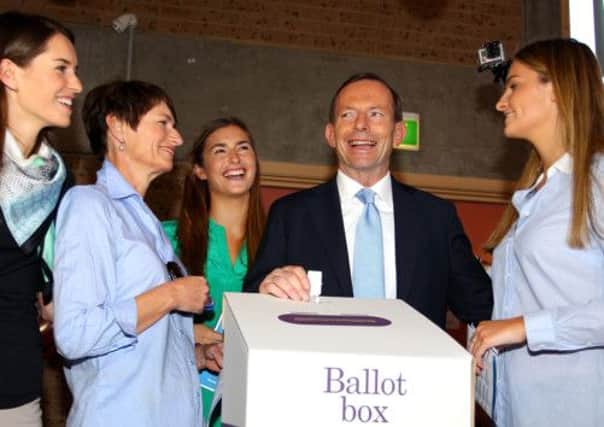Tony Abbott watches as his daughters Bridget, Frances and Louise and his wife Margie cast their votes. Picture: Getty