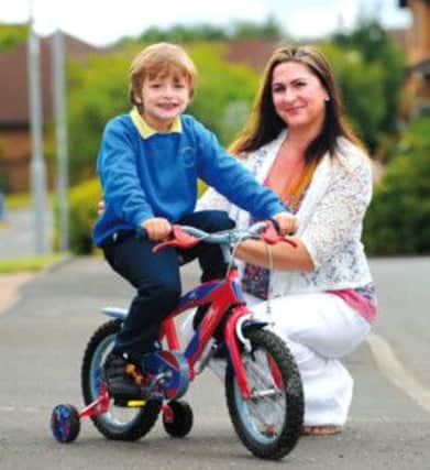 Catriona McRoberts with her son Kyran outside their home in East Kilbride. She is appealing against the decision. Picture: Robert Perry