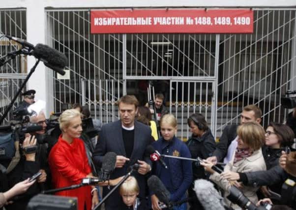 Russian opposition leader Alexei Navalny talks to the media outside a polling station in Moscow. Picture: Reuters